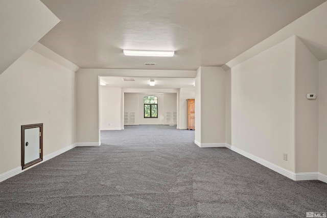 unfurnished room featuring dark colored carpet