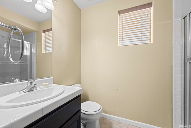 bathroom featuring a healthy amount of sunlight, vanity, toilet, and walk in shower