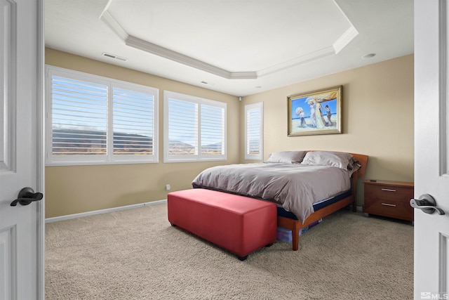 bedroom with crown molding, light colored carpet, and a raised ceiling