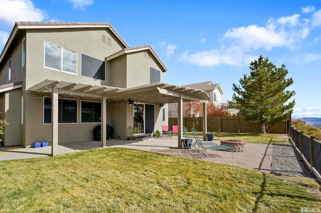 rear view of property with a pergola, a patio, and a yard