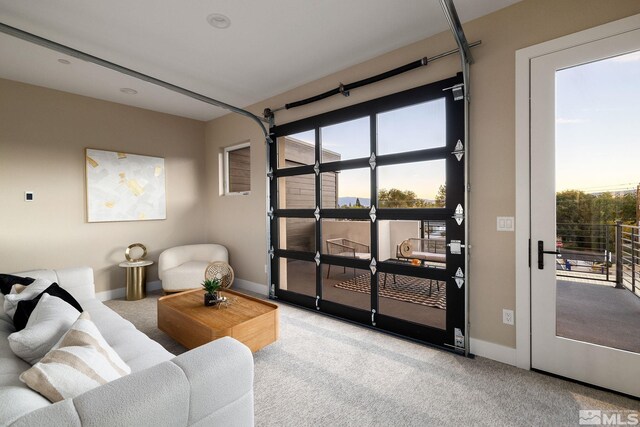 living room featuring light colored carpet and plenty of natural light