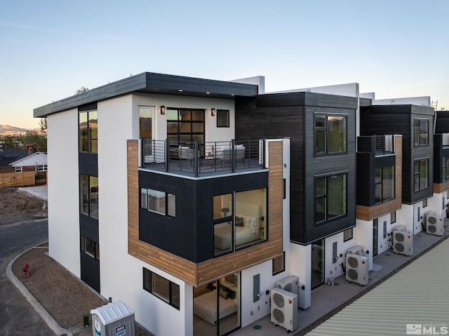 outdoor building at dusk featuring ac unit