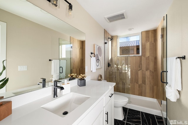 bathroom with vanity, an enclosed shower, and toilet