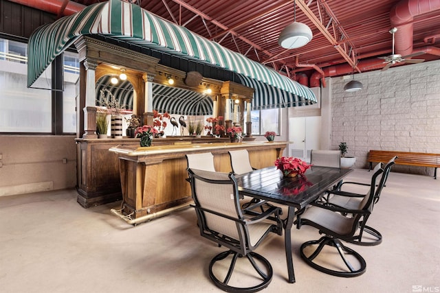 view of patio / terrace featuring ceiling fan and an outdoor bar