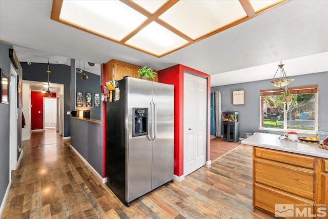 kitchen with hardwood / wood-style flooring, lofted ceiling, stainless steel fridge with ice dispenser, and pendant lighting