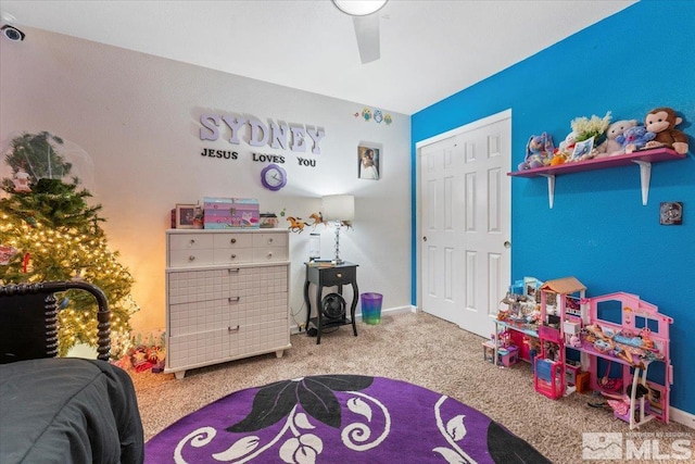 carpeted bedroom featuring a closet and ceiling fan