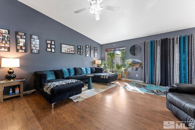 living room with ceiling fan, wood-type flooring, and vaulted ceiling