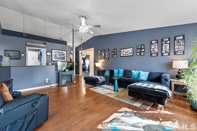 living room featuring ceiling fan, wood-type flooring, and vaulted ceiling