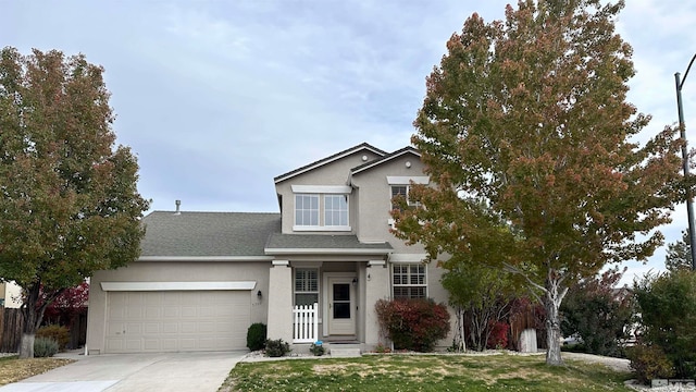 view of property with a front lawn and a garage