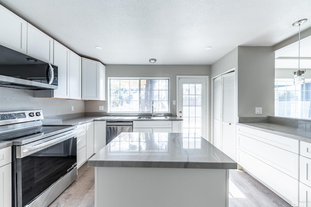 kitchen featuring a center island, white cabinets, and stainless steel appliances