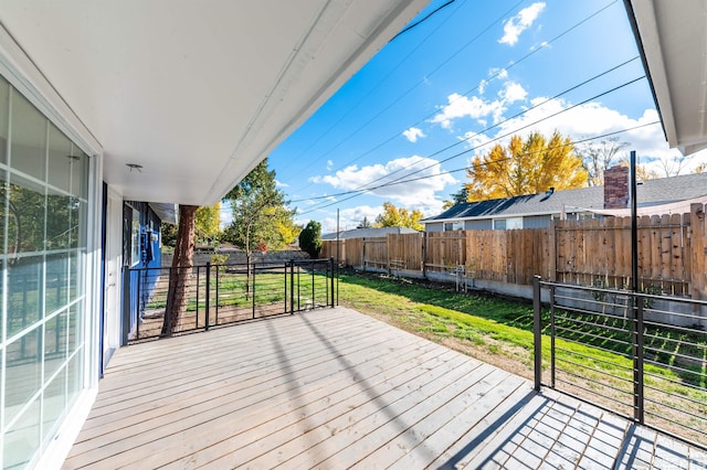 wooden terrace featuring a yard