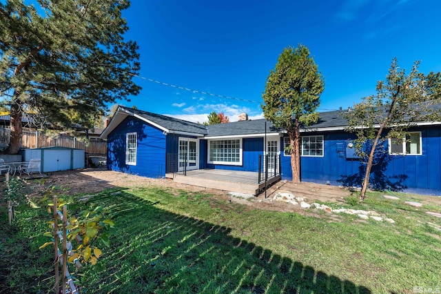 ranch-style home with a shed and a front lawn