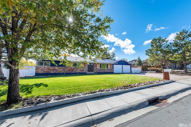 ranch-style home with a front yard and a garage