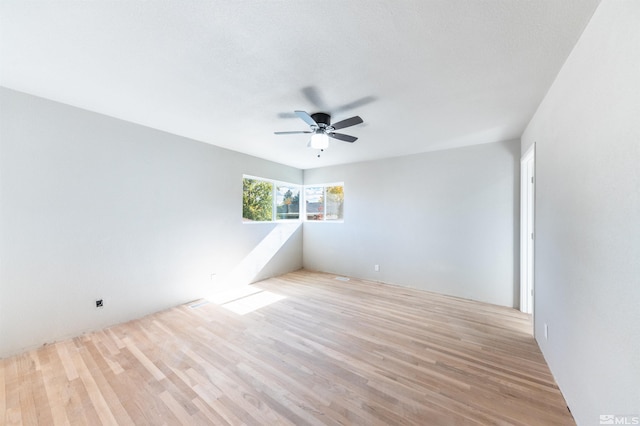 spare room with light hardwood / wood-style flooring and ceiling fan