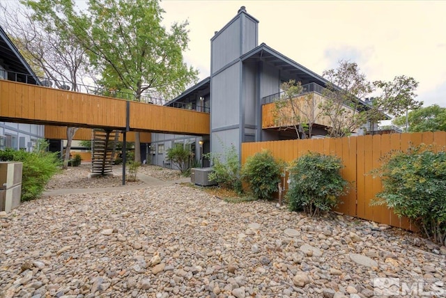 view of side of home with central air condition unit