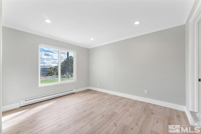 empty room with light hardwood / wood-style flooring, baseboard heating, and crown molding