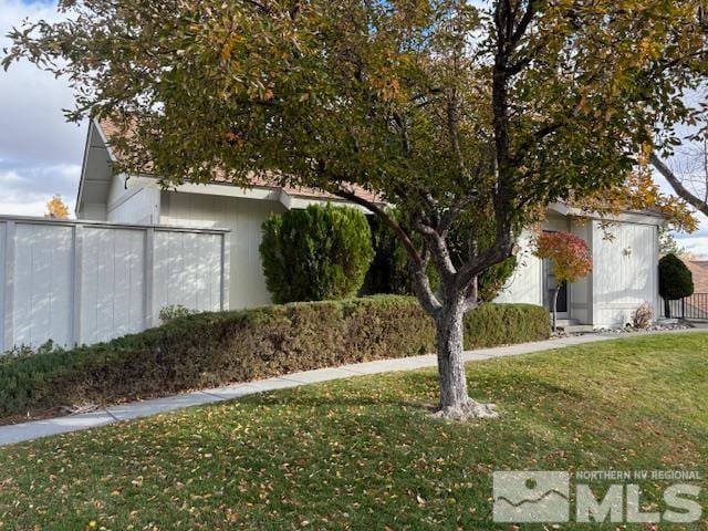 view of side of home featuring a lawn