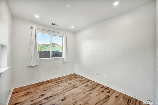 unfurnished room featuring light hardwood / wood-style floors