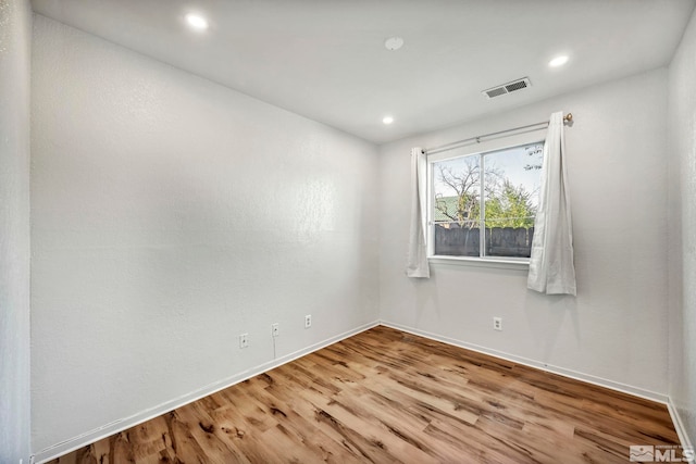 spare room with light hardwood / wood-style floors