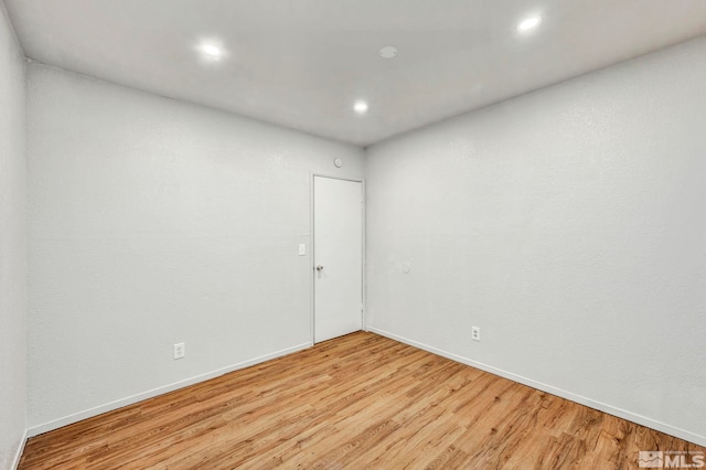 empty room with light hardwood / wood-style flooring