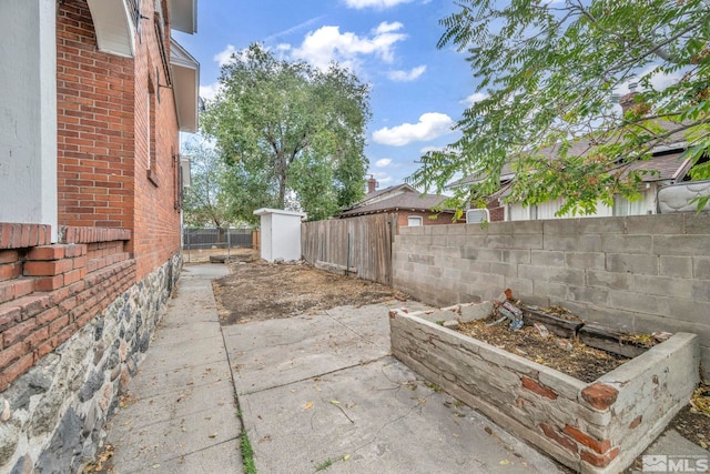 view of patio / terrace featuring a storage unit