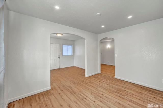 unfurnished room with light hardwood / wood-style floors