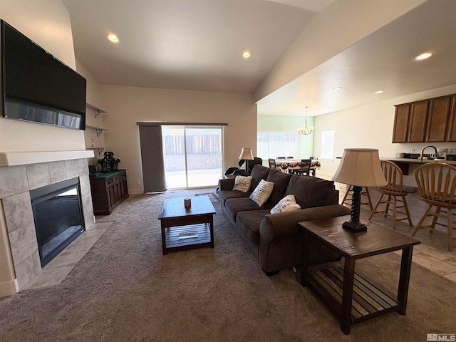 carpeted living room with lofted ceiling and a fireplace