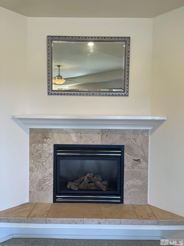 interior details with ceiling fan and a premium fireplace