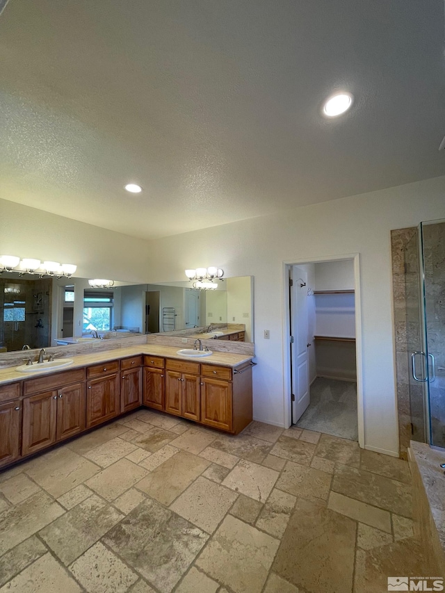 bathroom featuring vanity and a shower with door