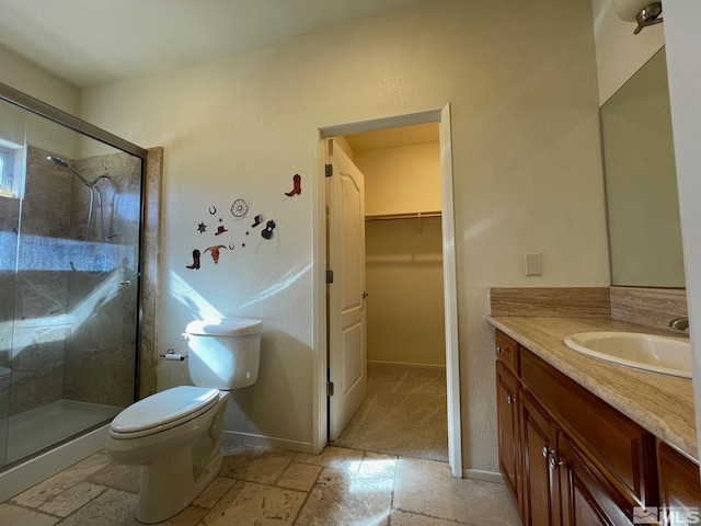 bathroom featuring vanity, toilet, and walk in shower