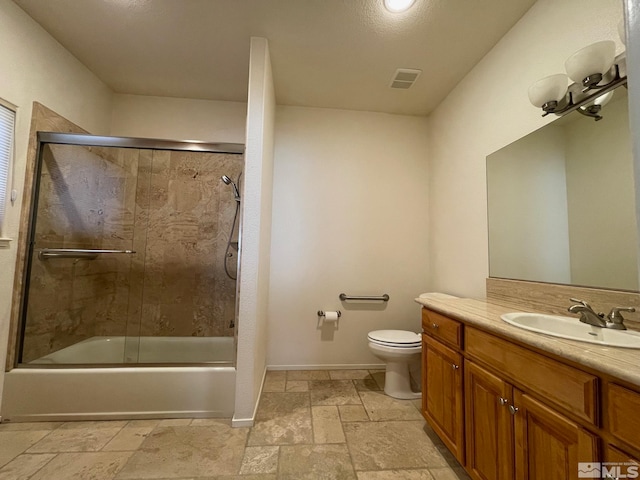 full bathroom with vanity, toilet, and shower / bath combination with glass door