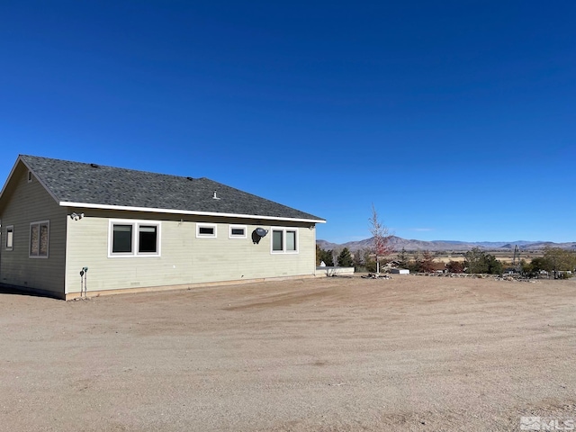 back of house with a mountain view