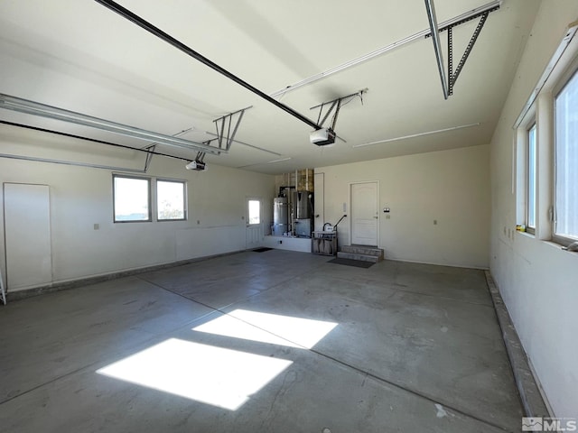 garage featuring a garage door opener and secured water heater