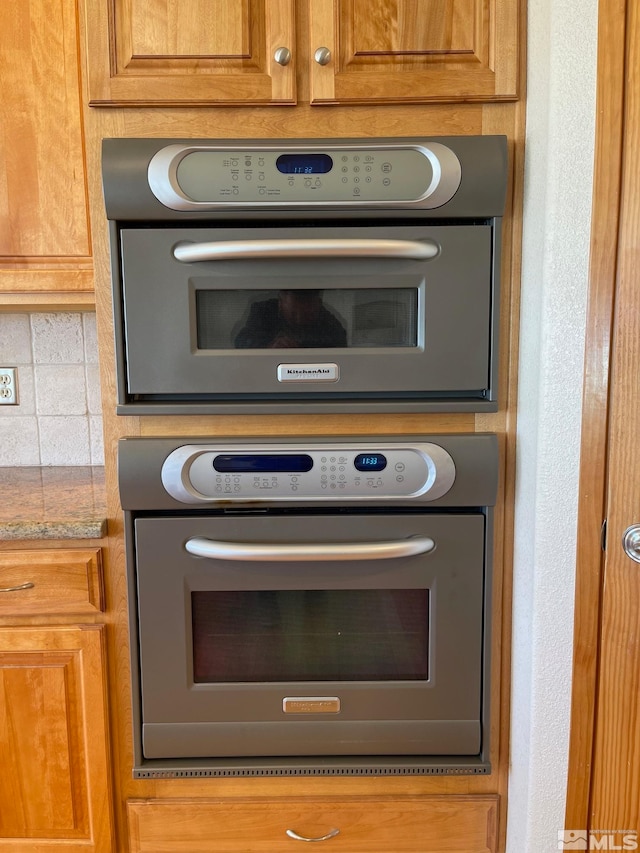 details with oven, tasteful backsplash, and light stone counters