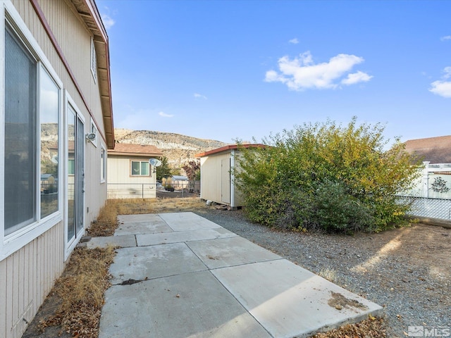 exterior space with a mountain view and a patio