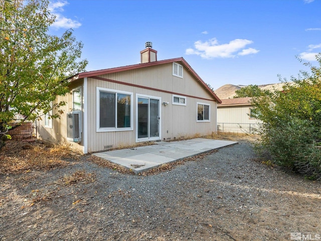 rear view of house featuring cooling unit and a patio