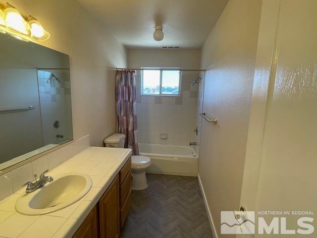 full bathroom featuring vanity, parquet floors, shower / bath combo, and toilet