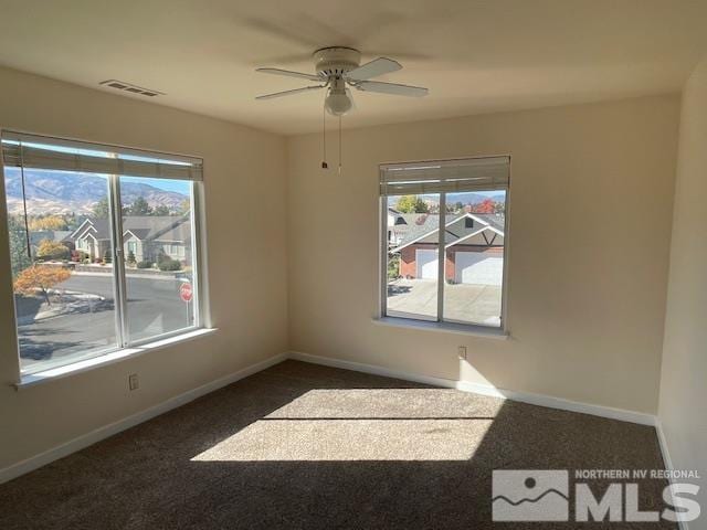 carpeted empty room featuring ceiling fan