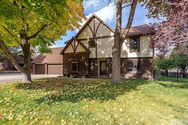 tudor home with a garage and a front yard