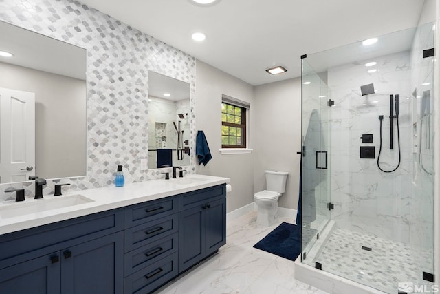 bathroom with a shower with shower door, vanity, and toilet