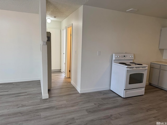 kitchen with white range with electric stovetop, a textured ceiling, and light hardwood / wood-style flooring