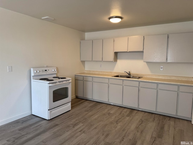 kitchen featuring white cabinetry, electric stove, sink, and light hardwood / wood-style flooring