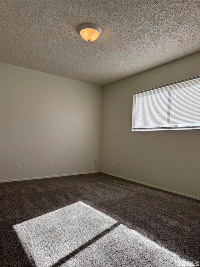 carpeted spare room with a textured ceiling