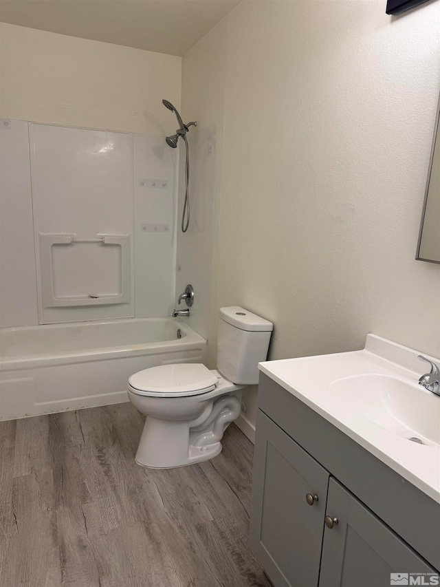 full bathroom featuring toilet, tub / shower combination, vanity, and hardwood / wood-style flooring