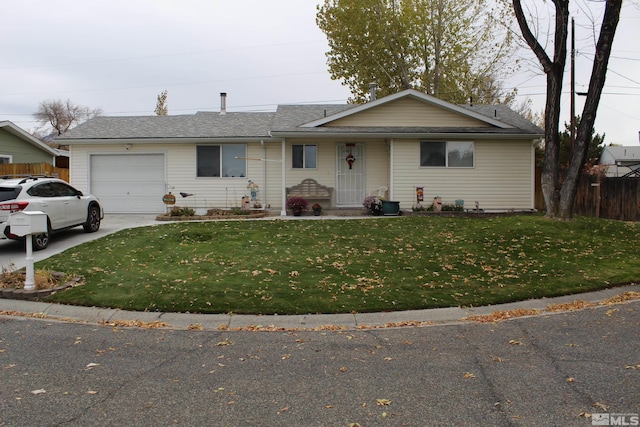 ranch-style house featuring a garage and a front yard