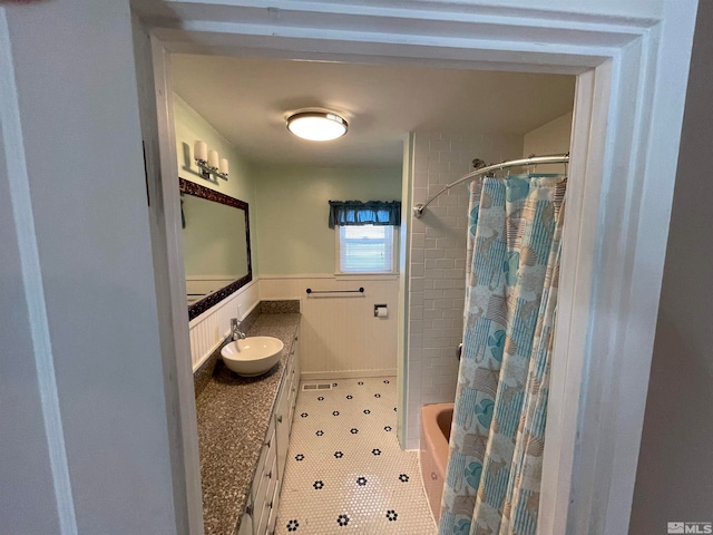 bathroom with tile patterned flooring, vanity, and shower / bathtub combination with curtain