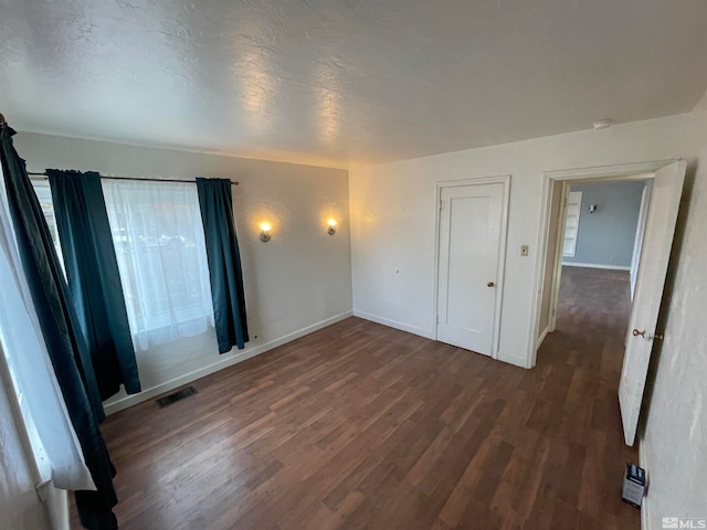 unfurnished bedroom featuring dark wood-type flooring