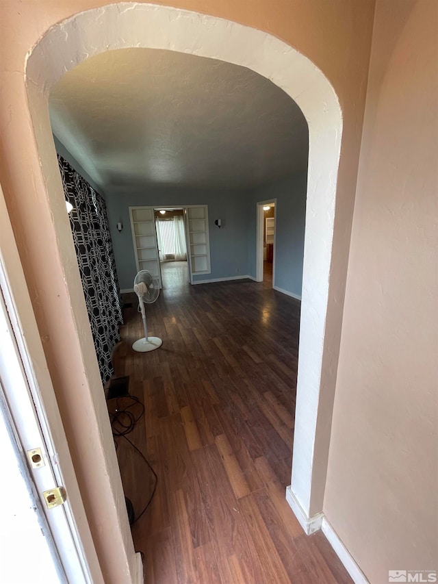 hallway with hardwood / wood-style floors