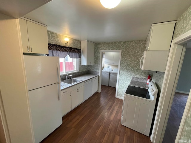 kitchen with white cabinetry, dark hardwood / wood-style flooring, washer / clothes dryer, sink, and white appliances