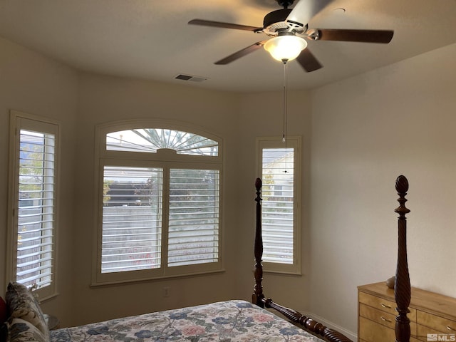 bedroom featuring multiple windows and ceiling fan